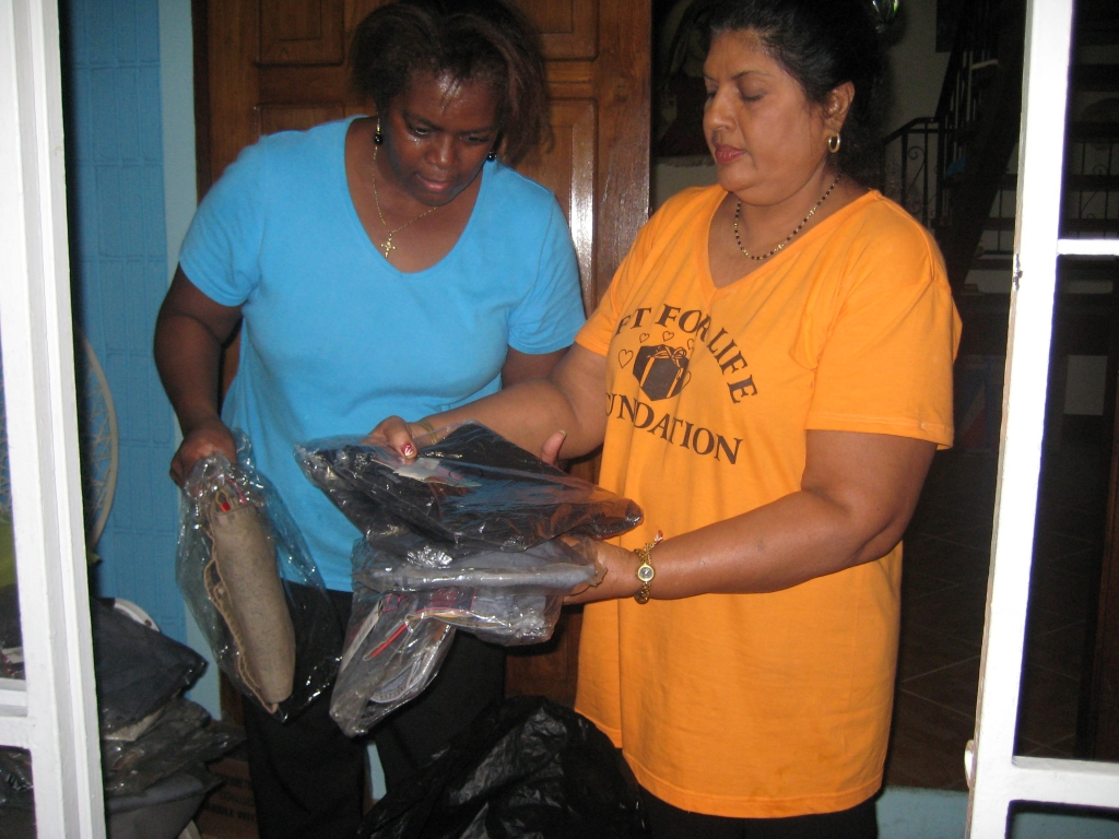 Gift for Life representative sorts the sizes of the brand new clothes with caretaker for the children